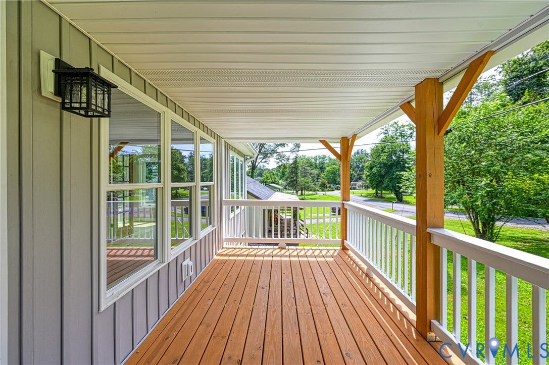 309 Ellis Drive, Louisa, VA 23093 Covered porch with wood-finish decking, white railings, and natural wood support beams
