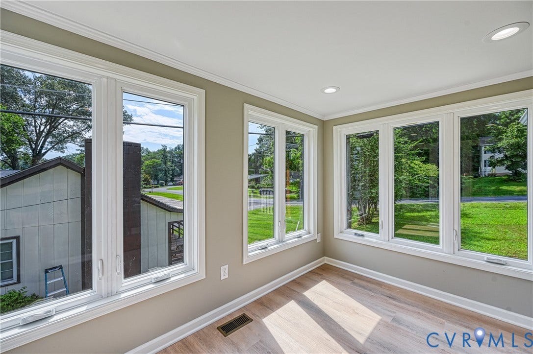 309 Ellis Drive, Louisa, VA 23093 Sunlit interior space featuring expansive windows, wood-finish flooring, recessed ceiling lighting, and crown molding