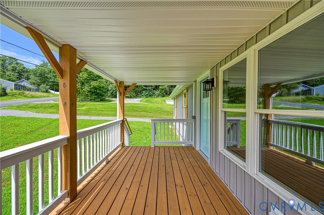309 Ellis Drive, Louisa, VA 23093 Covered front porch featuring wood-finish decking, white railings, and natural wood support columns