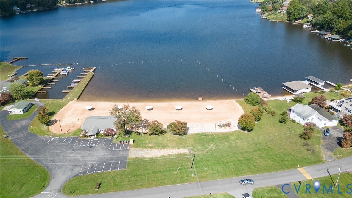 309 Ellis Drive, Louisa, VA 23093 Expansive waterfront property featuring a large sand beach, private boat docks, and a paved parking area