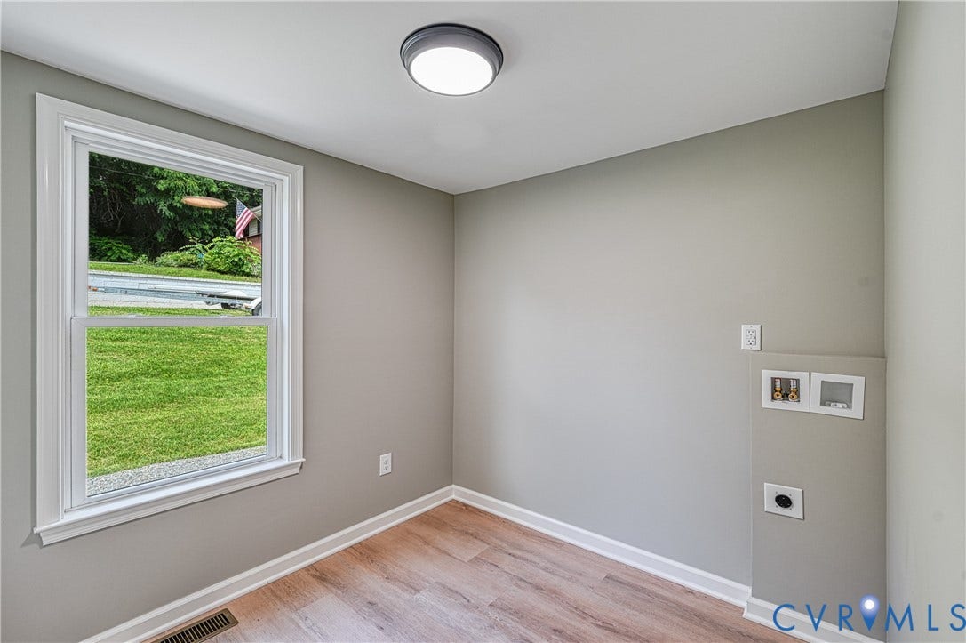 309 Ellis Drive, Louisa, VA 23093 Dedicated laundry area featuring a single window, overhead flush-mount lighting, wood-finish flooring, and light gray wall paint
