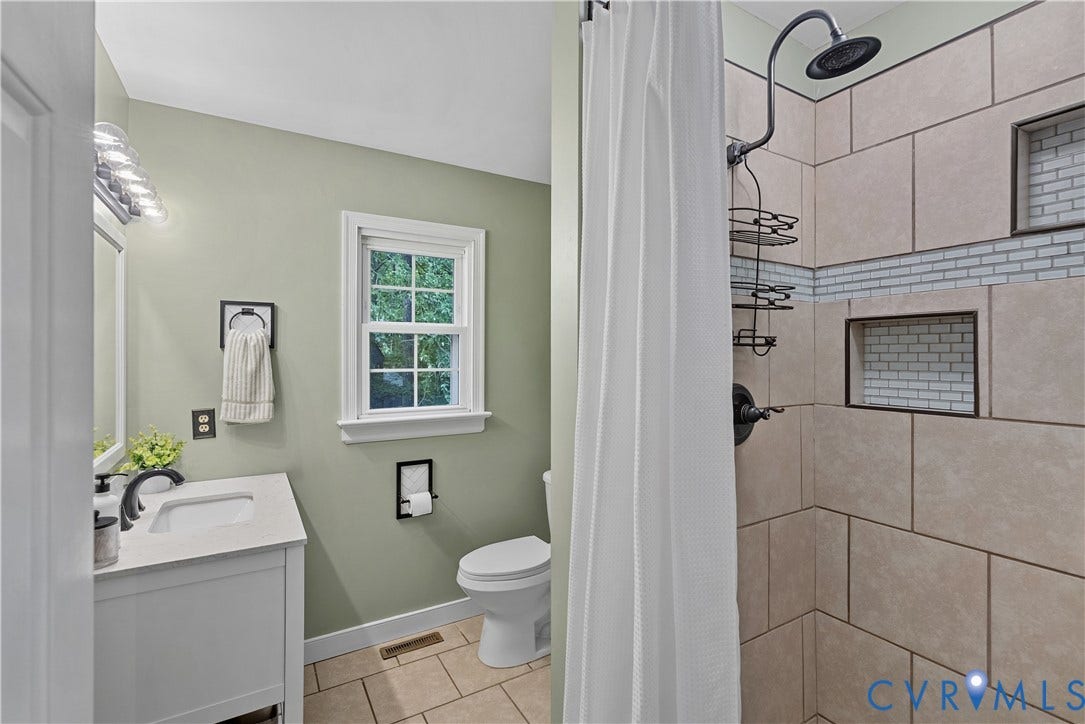 13908 Sterlings Bridge Road, Midlothian, VA 23112 Built-in shower niche with subway tile accent, full shower with overhead rain showerhead, vanity with undermount sink and quartz countertop, and a window with natural light
