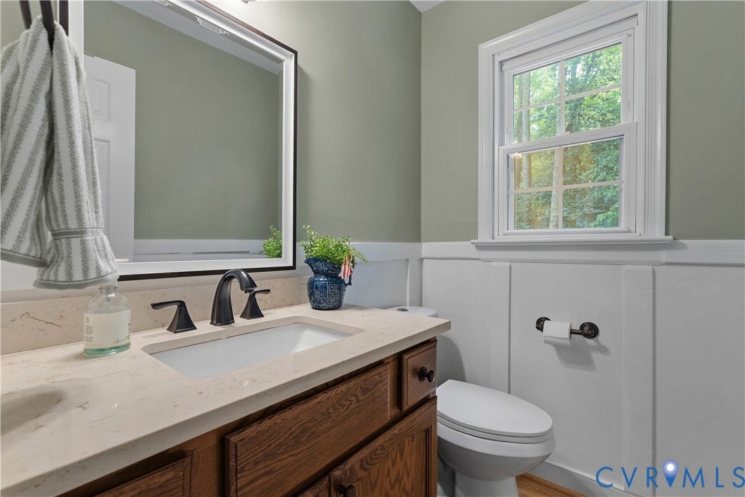 13908 Sterlings Bridge Road, Midlothian, VA 23112 Built-in vanity with a rectangular sink, dark bronze-finish faucet, light-toned countertop, and wood-finish cabinetry