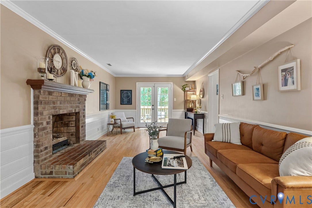 13908 Sterlings Bridge Road, Midlothian, VA 23112 Brick fireplace with mantel, hardwood flooring, white wainscoting, crown molding, and double glass-paneled doors