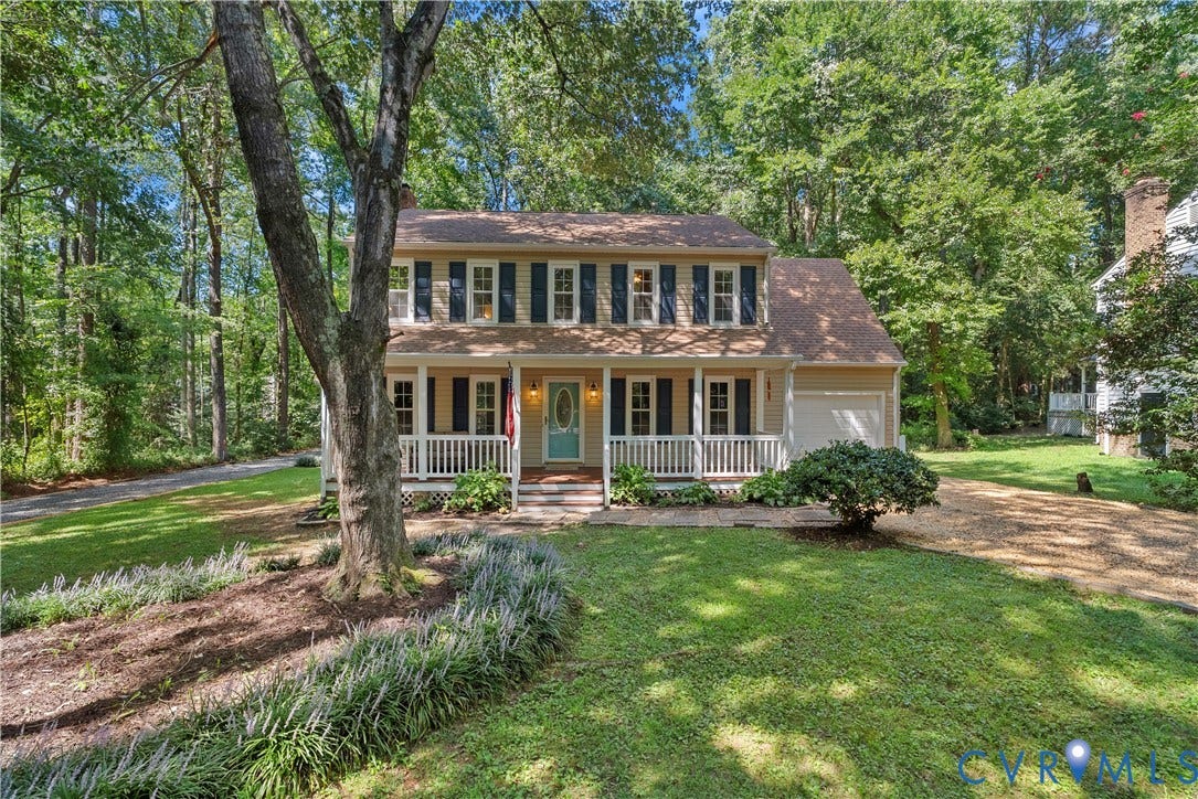 13908 Sterlings Bridge Road, Midlothian, VA 23112 Two-story residence featuring a covered front porch, attached garage, mature trees, and a gravel driveway