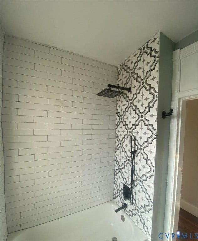 1100 W Marshall Street, Richmond, VA 23220 Bathtub shower with subway tile surround, patterned accent tile, and matte black fixtures including a rain shower head and handheld sprayer