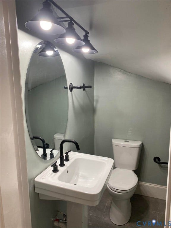 1100 W Marshall Street, Richmond, VA 23220 Pedestal sink with matte black faucet, oval mirror, and three-light vanity fixture
