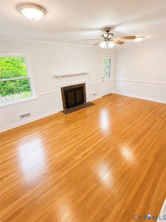 10250 Epsilon Road, Southwest, Richmond, VA 23235 Spacious room featuring wood-finish flooring, a brick-surround fireplace with a white mantel, ceiling fan with integrated lighting, recessed lighting, and a glass-paneled door