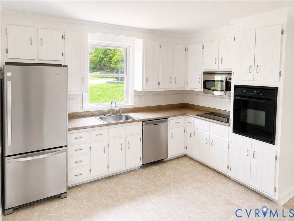 10250 Epsilon Road, Southwest, Richmond, VA 23235 Kitchen featuring white cabinetry, light-toned countertops, a stainless steel refrigerator, and a built-in oven with a microwave