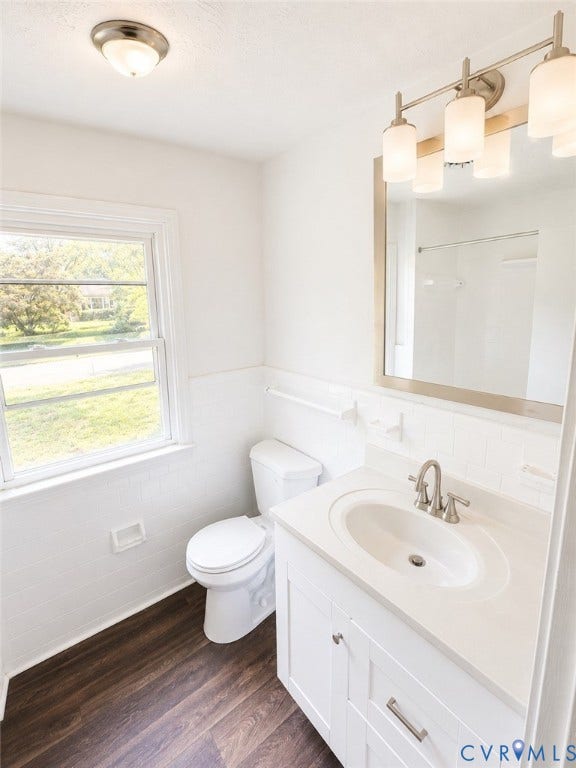 10250 Epsilon Road, Southwest, Richmond, VA 23235 Bathroom featuring a white vanity with an integrated sink, brushed nickel faucet, and wood-finish flooring