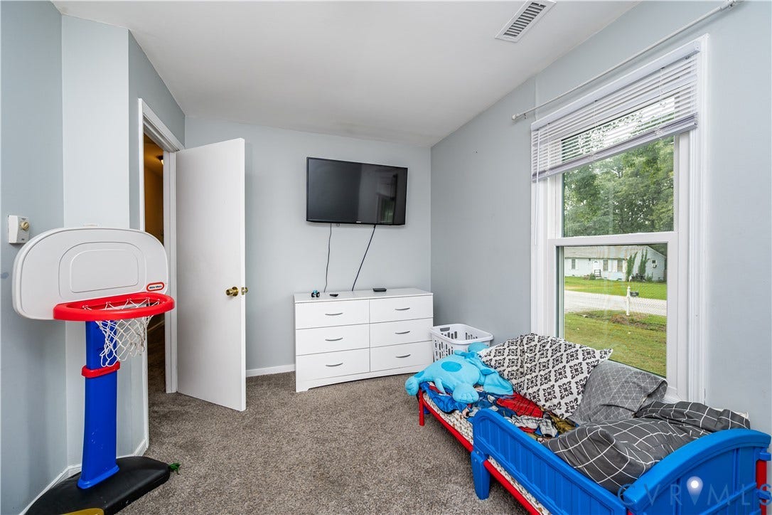 19105 Braebrook Drive, Chesterfield, VA 23834 Carpeted room featuring light gray walls, a single window with blinds, and a white interior door