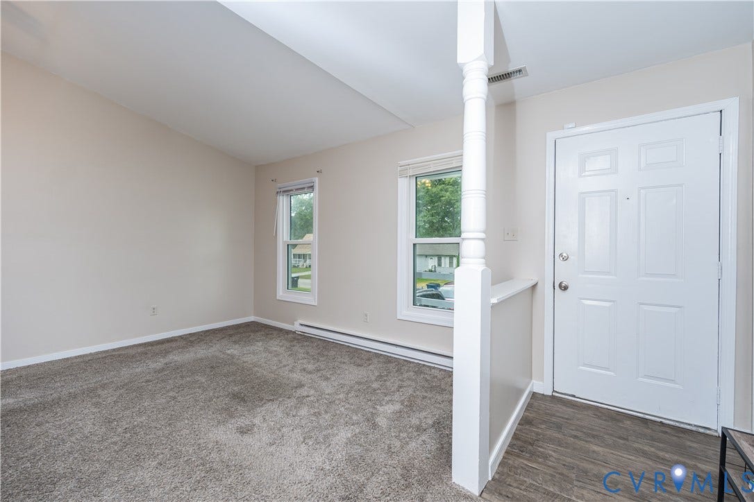 19105 Braebrook Drive, Chesterfield, VA 23834 Entryway featuring wood-finish flooring, a white paneled door, and a decorative half-wall with an architectural column