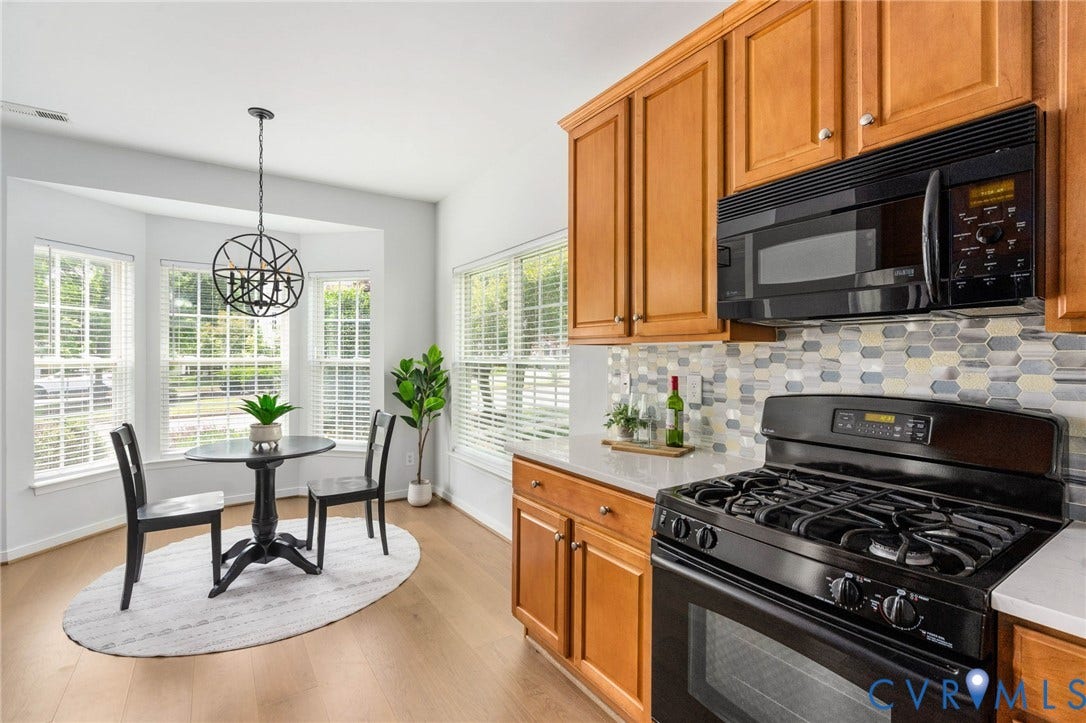 5806 Park Creste Drive, Glen Allen, VA 23059 Kitchen featuring light wood-finish flooring, warm-toned cabinetry, light countertops, and a mosaic tile backsplash