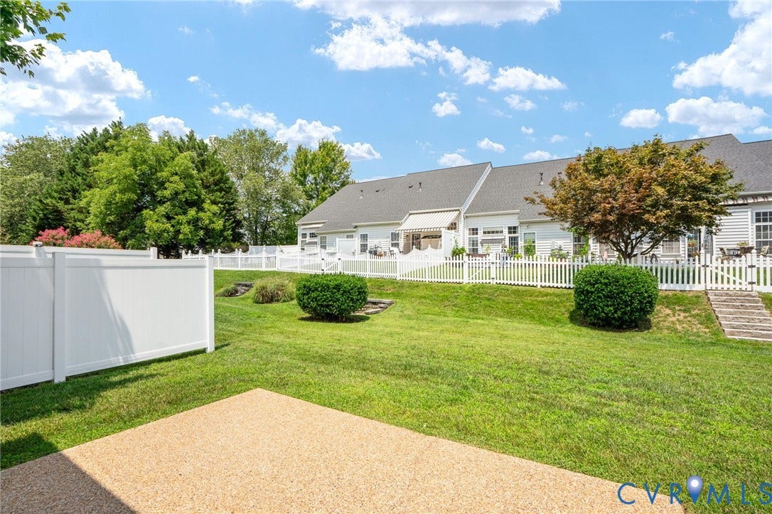 5806 Park Creste Drive, Glen Allen, VA 23059 Expansive backyard featuring a gravel patio, manicured lawn, and mature landscaping