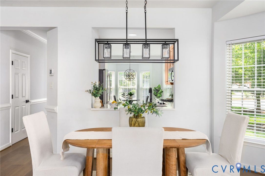 5806 Park Creste Drive, Glen Allen, VA 23059 Open concept dining area with a wood-finish dining table and a contemporary linear chandelier with clear glass shades