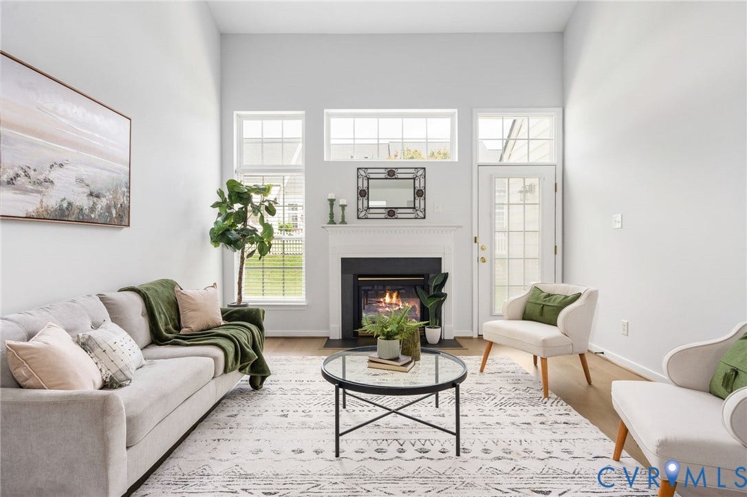 5806 Park Creste Drive, Glen Allen, VA 23059 Living room featuring a fireplace with a white mantel, high ceilings, multiple windows, and wood-finish flooring