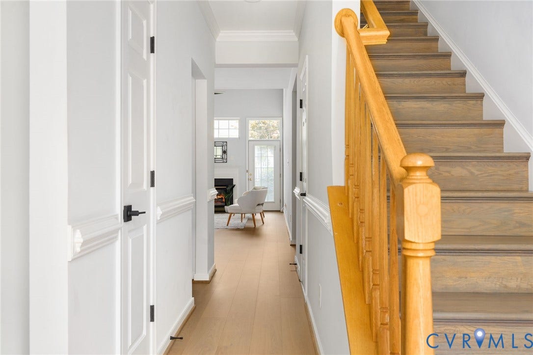 5806 Park Creste Drive, Glen Allen, VA 23059 Hallway with light wood-finish flooring, white paneled doors with matte black hardware, and crisp white trim