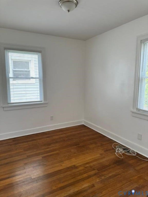 712 S Meadow Street, Richmond, VA 23220 Room with wood-finish flooring, two windows with blinds, and a semi-flush ceiling light fixture