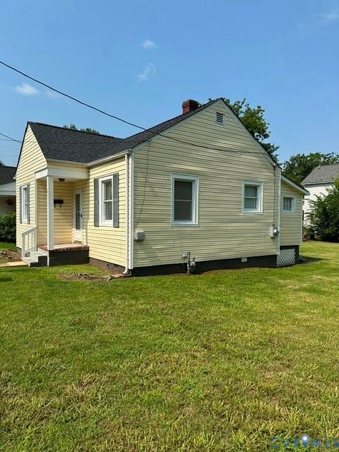 712 S Meadow Street, Richmond, VA 23220 Exterior featuring light yellow siding, white trim, and a dark shingle roof