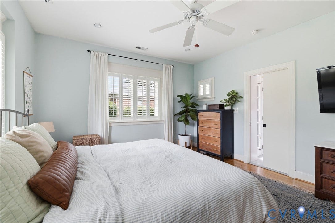 Hardwood flooring complements light blue walls and white trim