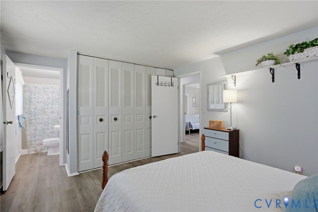 2007 Mountain Pine Boulevard, Three Pines, Richmond, VA 23235 Wood-finish flooring, white louvered closet doors, wall-mounted shelving with brackets, and a recessed ceiling light fixture