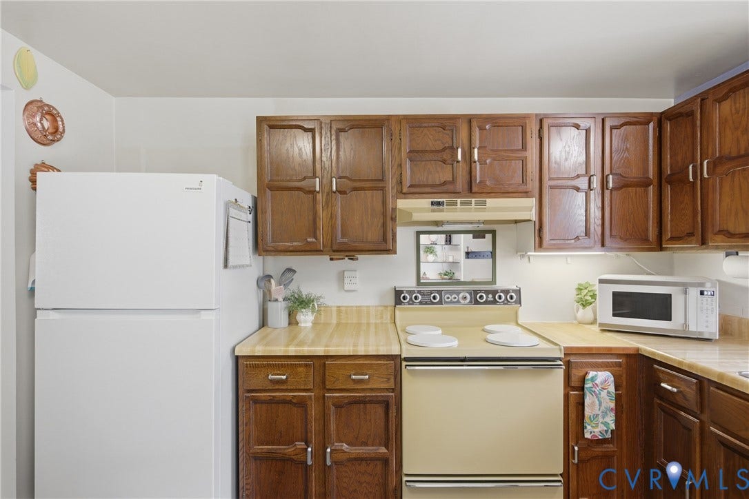 2007 Mountain Pine Boulevard, Three Pines, Richmond, VA 23235 Rich wood-finish cabinetry, light wood-finish countertops, and white appliances