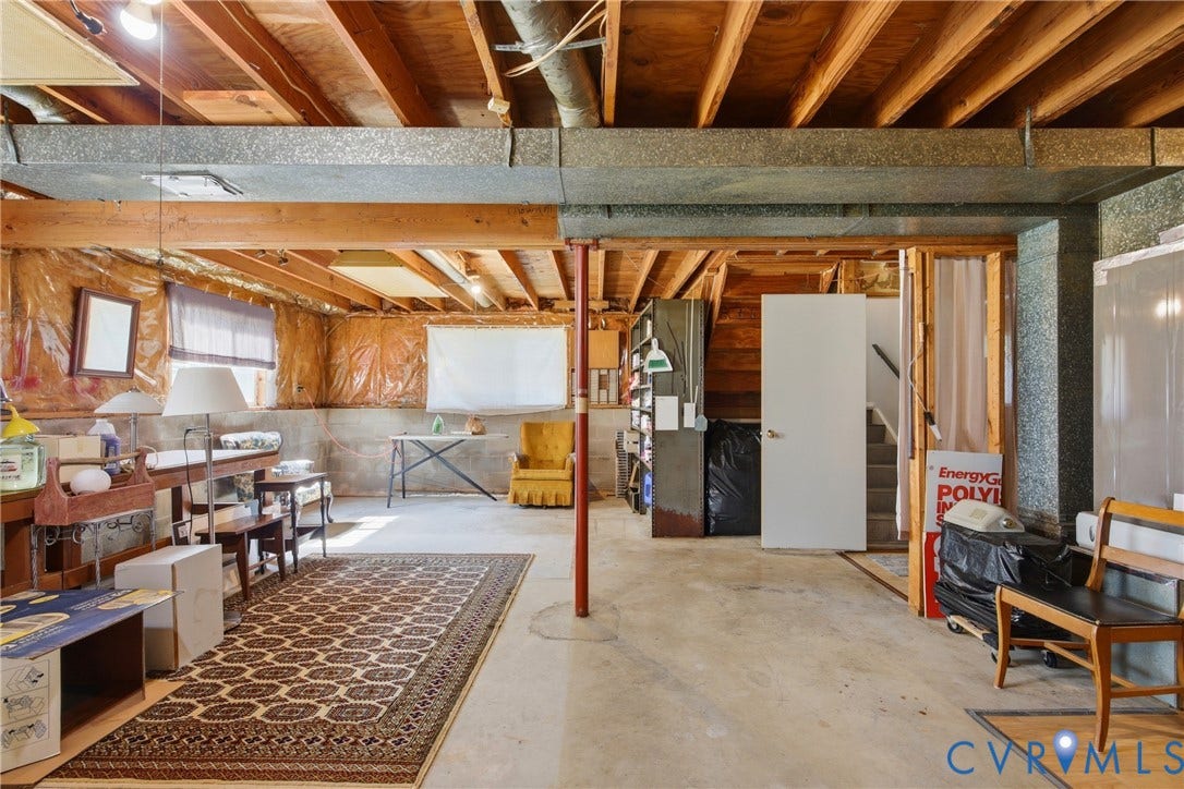 2007 Mountain Pine Boulevard, Three Pines, Richmond, VA 23235 Spacious basement workshop with exposed wood-beam ceiling, concrete flooring, and abundant natural light from windows
