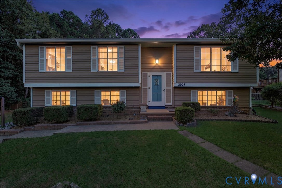 2007 Mountain Pine Boulevard, Three Pines, Richmond, VA 23235 Two-story exterior with horizontal siding, a blue entry door, multiple windows with white shutters, and an established front lawn