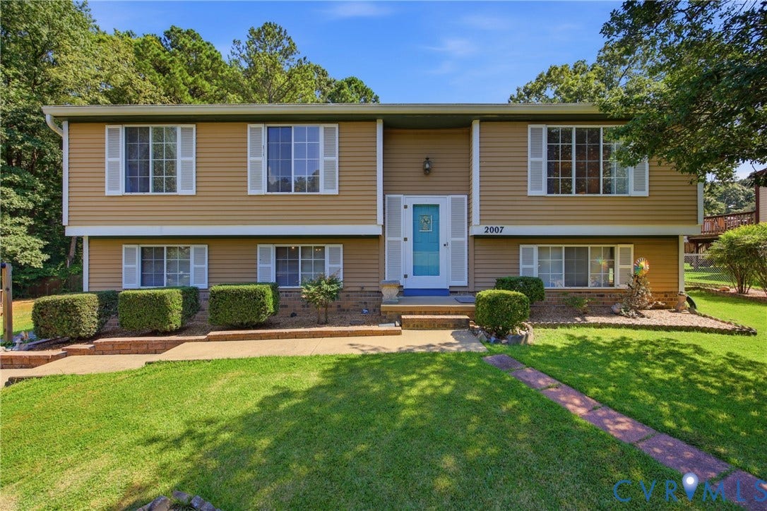 2007 Mountain Pine Boulevard, Three Pines, Richmond, VA 23235 Split-level home featuring tan vinyl siding, a welcoming turquoise entry door, and multiple large windows providing natural light throughout