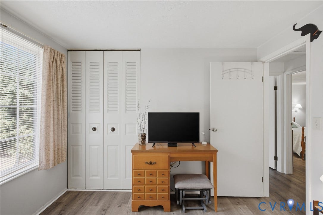 2007 Mountain Pine Boulevard, Three Pines, Richmond, VA 23235 Window with horizontal blinds and drapes, louvered bi-fold closet doors, wood-finish flooring, and white interior doors
