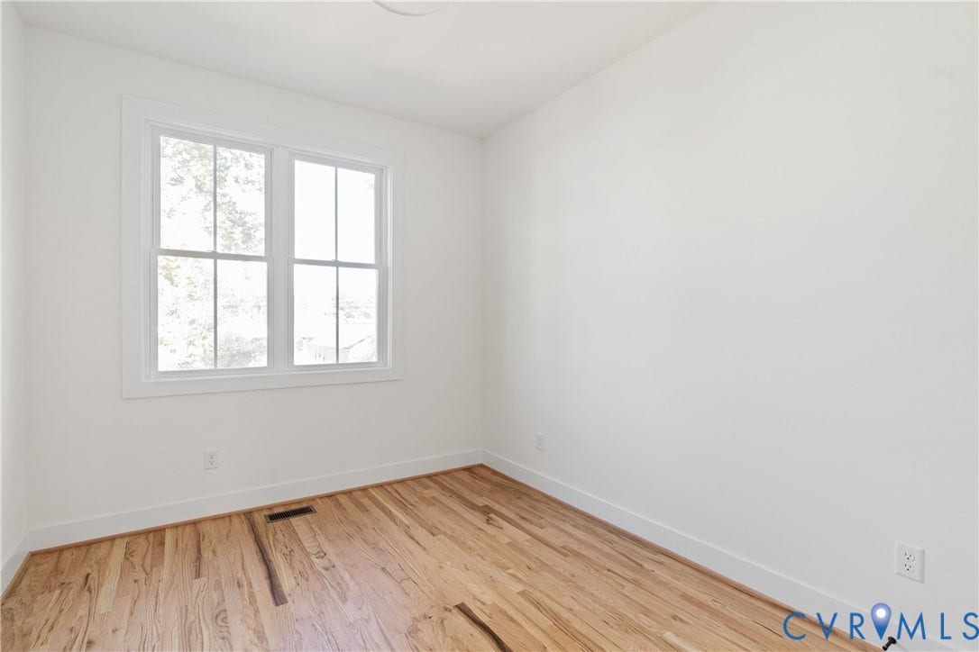 1103 Carlisle Avenue, Montrose Heights, Richmond, VA 23231 Neutral interior room featuring a double-hung window with white trim, wood-finish flooring, and white baseboards