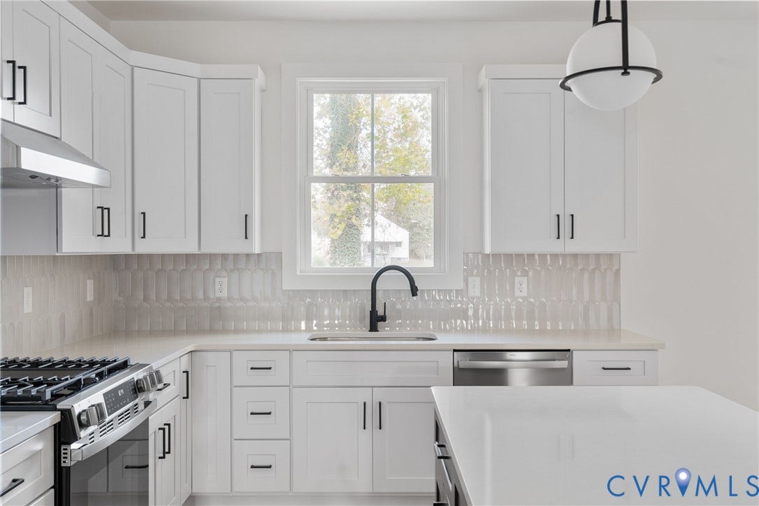 1103 Carlisle Avenue, Montrose Heights, Richmond, VA 23231 Contemporary kitchen featuring white cabinetry with matte black hardware, stainless steel appliances, light countertops, and a unique tiled backsplash