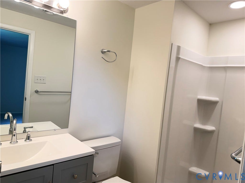 1308 Bentbrook Drive, Henrico, VA 23231 Bathroom featuring a gray vanity with an integrated white sink, chrome faucet, and a large wall-mounted mirror