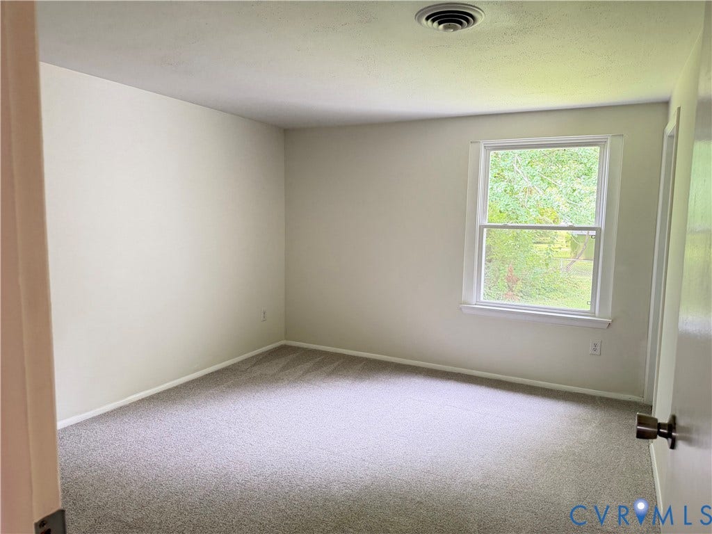 1308 Bentbrook Drive, Henrico, VA 23231 Windowed interior space featuring light-toned walls, textured gray carpeting, and white trim
