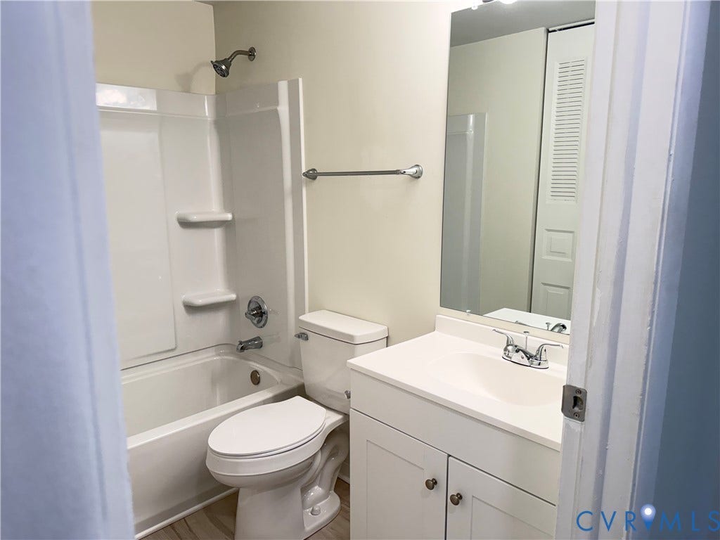 1308 Bentbrook Drive, Henrico, VA 23231 Bathroom featuring a full tub/shower combination, white vanity with integrated sink, chrome fixtures, and a mirrored medicine cabinet