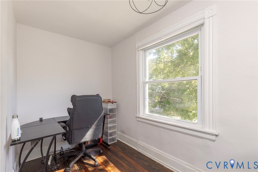 716 E Gladstone Avenue, Richmond, VA 23222 Hardwood flooring, single pane window, window trim with decorative corner blocks, and white painted walls