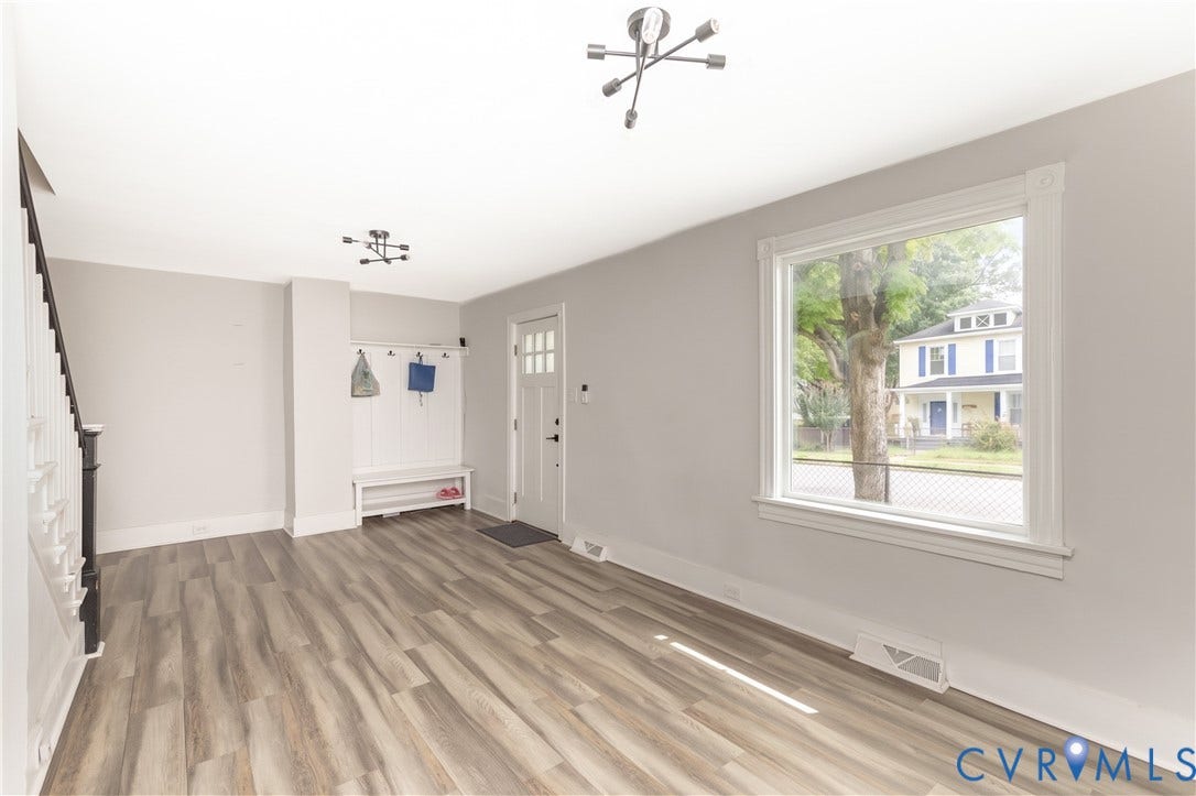 716 E Gladstone Avenue, Richmond, VA 23222 Wood-finish flooring, white trim, and a built-in entryway bench with storage