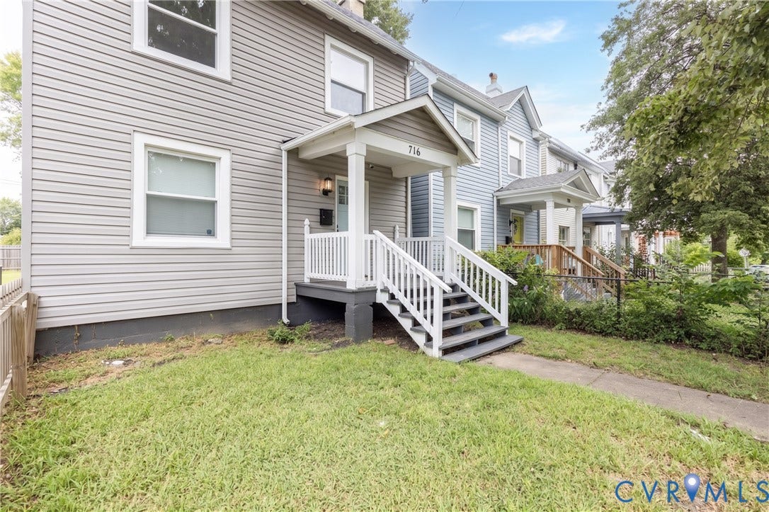 716 E Gladstone Avenue, Richmond, VA 23222 Siding exterior with multiple windows, covered front porch, white railings, and concrete steps
