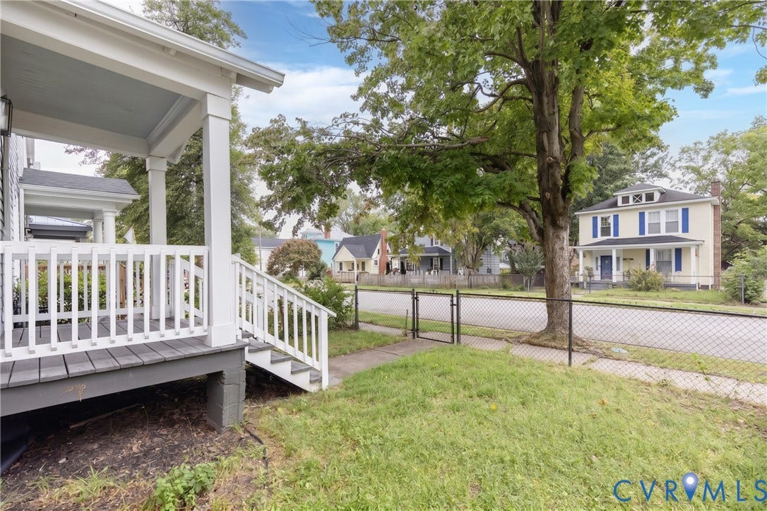716 E Gladstone Avenue, Richmond, VA 23222 Expansive front porch with white railings and steps, featuring a light blue ceiling