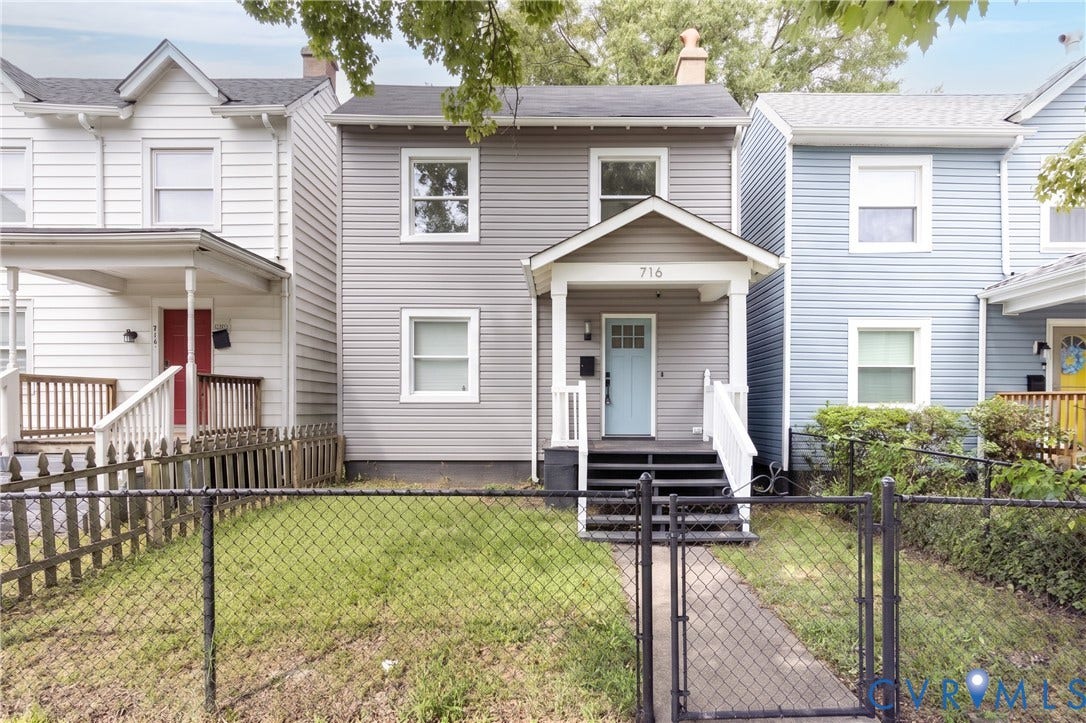 716 E Gladstone Avenue, Richmond, VA 23222 Two-story residence with gray siding, white trim windows, a light blue front door, and a covered porch