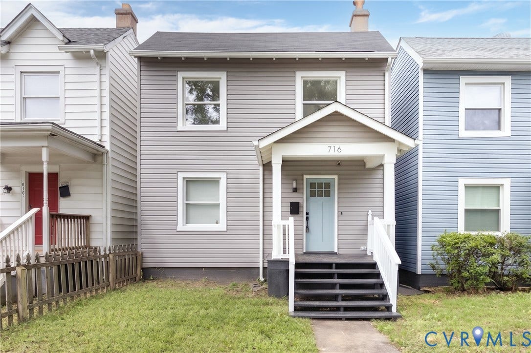 716 E Gladstone Avenue, Richmond, VA 23222 Gray siding exterior with a light blue front door, covered porch, white railings, and a dark shingled roof