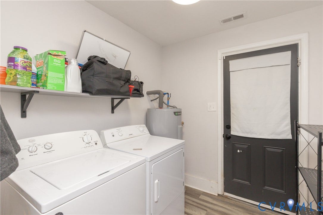 716 E Gladstone Avenue, Richmond, VA 23222 Laundry area featuring a top-load washer, dryer, wall-mounted shelving, and wood-finish flooring