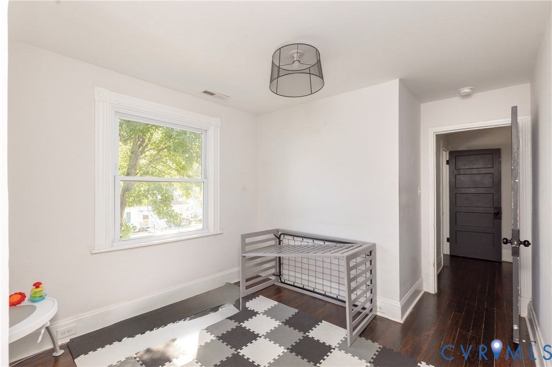 716 E Gladstone Avenue, Richmond, VA 23222 Hardwood flooring, painted interior door, window with white trim, and a ceiling-mounted light fixture
