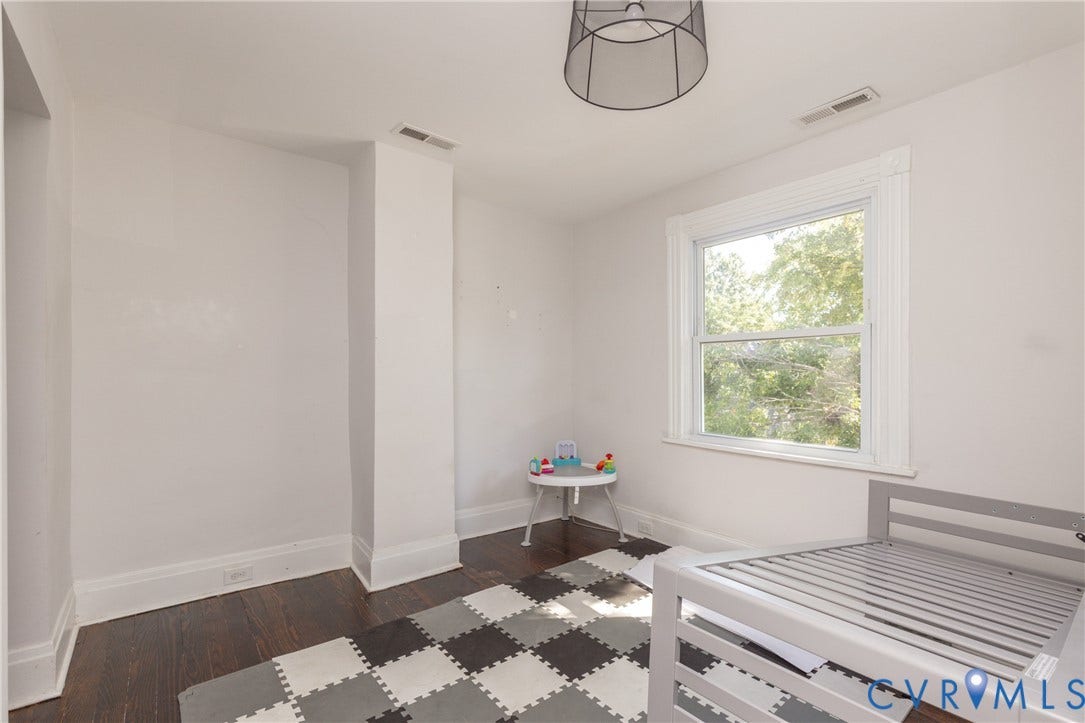 716 E Gladstone Avenue, Richmond, VA 23222 Dark wood-finish flooring, white trim, and a window with white casing