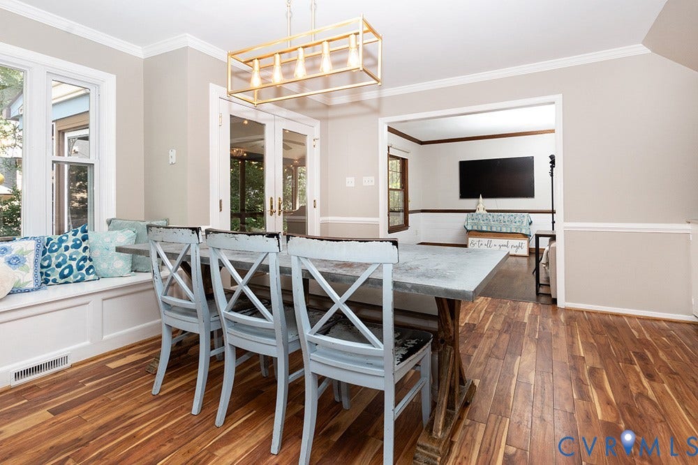 419 Rossmere Drive, Walton Park, Midlothian, VA 23114 Dining area featuring wood-finish flooring, a built-in window seat, a rectangular gold-finish linear chandelier, and double glass-paneled doors