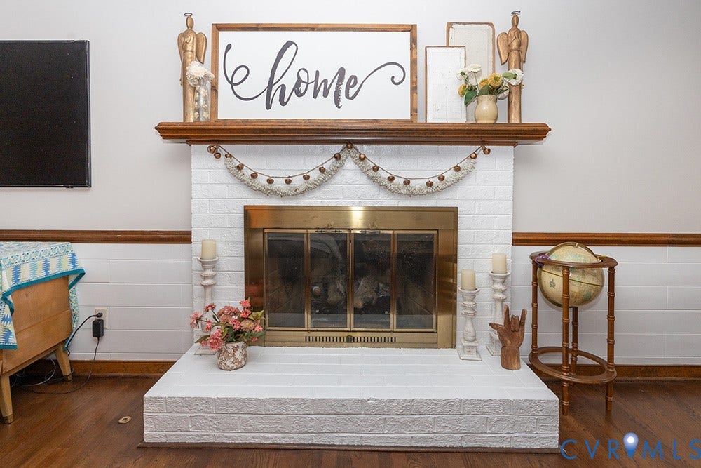 419 Rossmere Drive, Walton Park, Midlothian, VA 23114 Fireplace featuring white-painted brick surround and hearth, a brass firebox insert, and a wood mantel