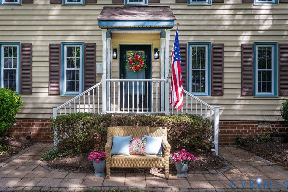 419 Rossmere Drive, Walton Park, Midlothian, VA 23114 Colonial-style exterior featuring light-colored siding, brown window shutters, and blue window trim