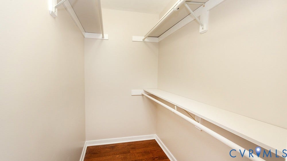 419 Rossmere Drive, Walton Park, Midlothian, VA 23114 Spacious walk-in closet featuring white painted walls, recessed lighting, wood-finish flooring, and built-in shelving with a sturdy support rod for hanging storage