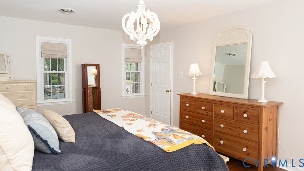 419 Rossmere Drive, Walton Park, Midlothian, VA 23114 Bright bedroom featuring two double-hung windows with roman shades, a white ceiling fan light fixture, and a white interior door