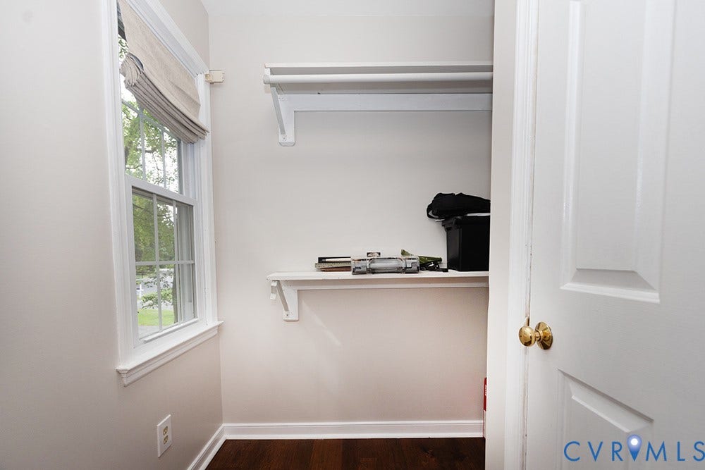 419 Rossmere Drive, Walton Park, Midlothian, VA 23114 Built-in closet system with shelving and hanging rod, featuring a window with a fabric roman shade